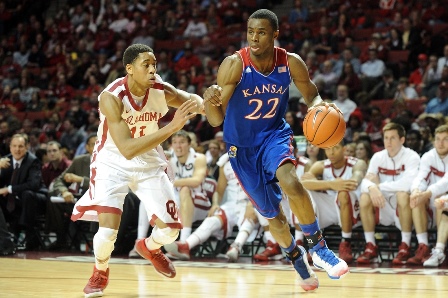 Jan 8, 2014; Norman, OK, USA; Kansas Jayhawks guard Andrew Wiggins (22) handles the ball while being guarded by Oklahoma Sooners guard Isaiah Cousins (11) during the first half at Lloyd Noble Center. Mandatory Credit: Mark D. Smith-USA TODAY Sports